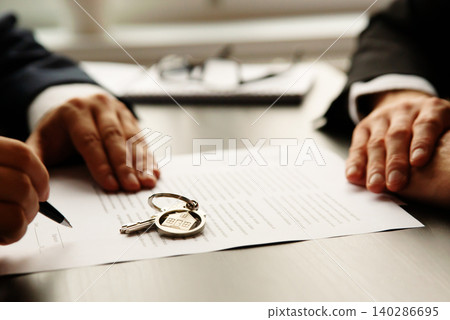 Real estate agent signing a contract buy-sell home Real estate agent signing a contract buy-sell home 140286695