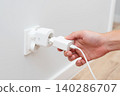 Man plug charger into smart socket 140286707