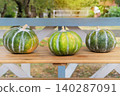 Pumpkins in autumn decor of street cafe. Decorative pumpkins on street table. 140287091