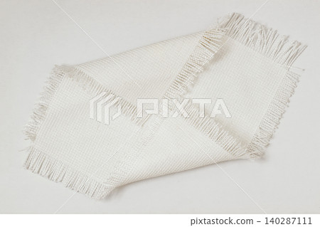 Fabric texture sample with woven threads and fringe edges placed on surface, textile sample, neutral modern tone, detailed weave pattern for design. Natural background, fabric texture Fabric texture sample with woven threads and fringe edges placed on surface, textile sample, neutral modern tone, detailed weave pattern for design. Natural background, fabric texture 140287111