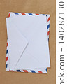 Envelope on kraft paper background with airmail border, mail stationery, copy space for postal design, greeting cards. Concept of envelope, correspondence, delivery, invitation, message 140287130