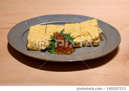 Japanese dish of rolled omelet topped with salmon roe 140287215