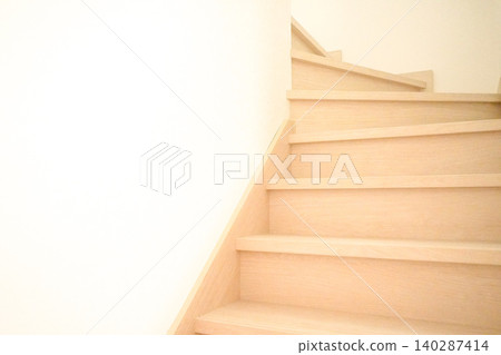 Bright wood-grain indoor staircase and white wall interior 140287414