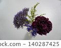 A mini bouquet of carnations and seasonal small flowers that stand out against a white background. 140287425