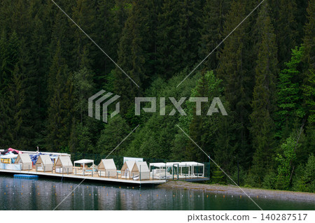 waterfront lounge resort place on water lake forest edge evergreen pine wood land background aerial waterfront lounge resort place on water lake forest edge evergreen pine wood land background aerial 140287517