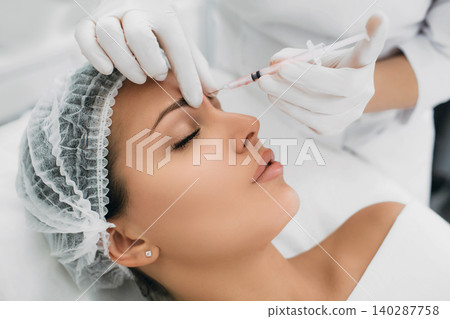 woman receiving injection on face, mesotherapy procedure woman receiving injection on face, mesotherapy procedure 140287758