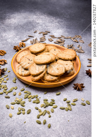 Healthy seeded cookies on plate with various seeds Healthy seeded cookies on plate with various seeds 140287827