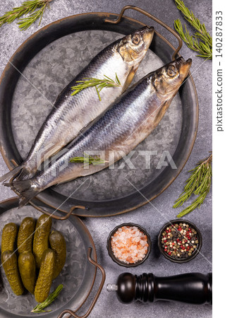 Pickled herring fish with rosemary and gherkins Pickled herring fish with rosemary and gherkins 140287833