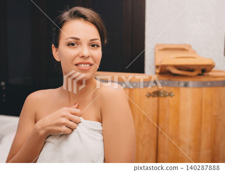 beautiful woman after relaxing in spa wooden cedar bathtub smiling at camera beautiful woman after relaxing in spa wooden cedar bathtub smiling at camera 140287888