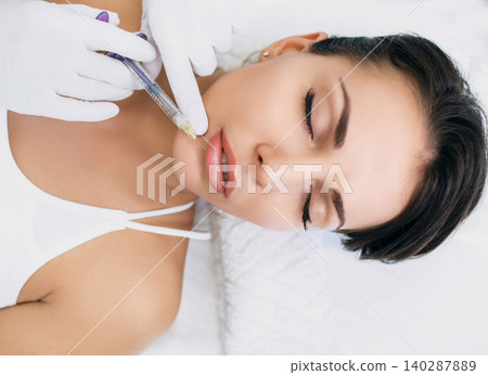 woman having lip injections, procedure lip augmentation woman having lip injections, procedure lip augmentation 140287889