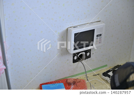 Installation of a remote control for an eco-friendly water heater (EcoCute) in the bathroom. Installation of a remote control for an eco-friendly water heater (EcoCute) in the bathroom. 140287957