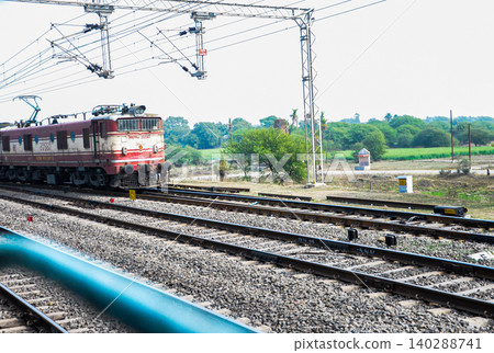 Electric Train Passing Through Rural Railway Tracks Electric Train Passing Through Rural Railway Tracks 140288741