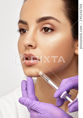 Sensual female lips, procedure lip augmentation. Syringe near woman's mouth, injections for increase lips shape, high quality Sensual female lips, procedure lip augmentation. Syringe near woman's mouth, injections for increase lips shape, high quality 140288768