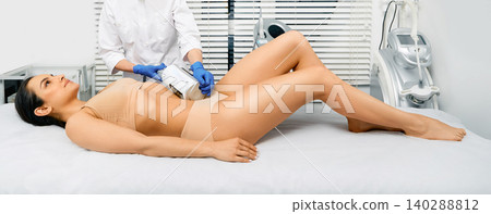 Belly massage with endosphere machine for woman's body correction at modern cosmetology clinic 140288812