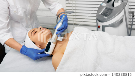 Facial endospheres therapy for correction oval female face with beautician at modern cosmetology clinic Facial endospheres therapy for correction oval female face with beautician at modern cosmetology clinic 140288815
