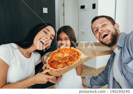 Family enjoying pizza lunch. Little girl having fun with her family Family enjoying pizza lunch. Little girl having fun with her family 140289240