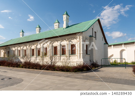 Historic White Stone Building With Green Roof And Ornate Windows Under Blue Sky Historic White Stone Building With Green Roof And Ornate Windows Under Blue Sky 140289430
