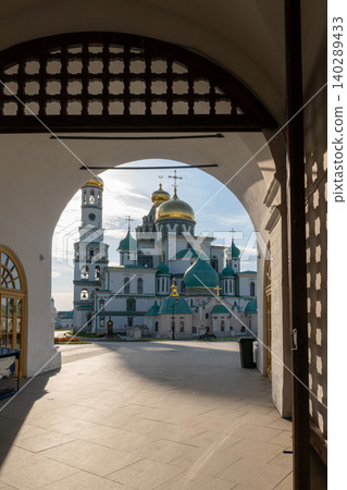 View Through Archway of Russian Orthodox Monastery With Gold and Green Domes at Sunrise 140289433