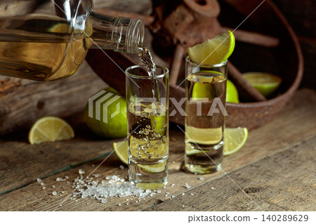 Tequila with salt and lime slices. Tequila with salt and lime slices. 140289629