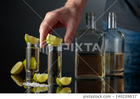 Gold tequila with sea salt and lime slices. 140289637