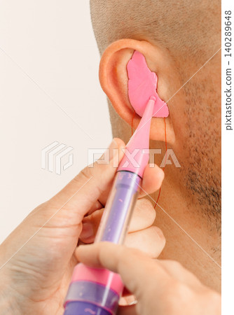 Process of making earplug from an impression of an individual s human ear. Ear close-up. Personally molded earplugs. Solution for noisy places. Part of the set Process of making earplug from an impression of an individual s human ear. Ear close-up. Personally molded earplugs. Solution for noisy places. Part of the set 140289648