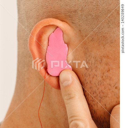 Process of making earplug from an impression of an individual s human ear. Ear close-up. Personally molded earplugs. Solution for noisy places. Part of the set Process of making earplug from an impression of an individual s human ear. Ear close-up. Personally molded earplugs. Solution for noisy places. Part of the set 140289649