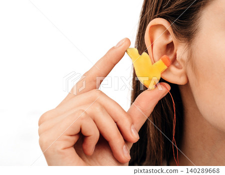 Process of making earplugs from an impression of an individual human ear. Ear close-up. Personally molded earplugs. Part of the set Process of making earplugs from an impression of an individual human ear. Ear close-up. Personally molded earplugs. Part of the set 140289668