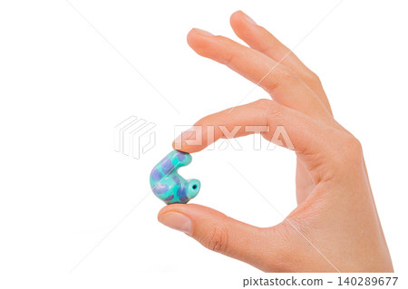 isolated on white earplug in hand. personally molded earplugs close-up isolated on white earplug in hand. personally molded earplugs close-up 140289677