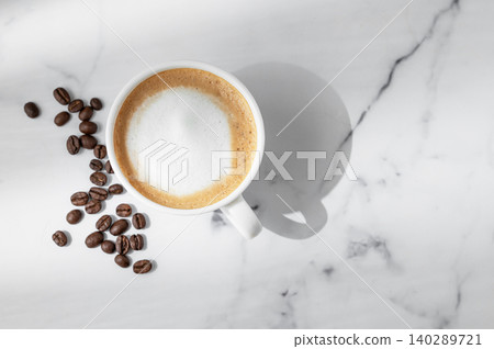Freshly brewed cappuccino coffee in a cup on a white marble background Freshly brewed cappuccino coffee in a cup on a white marble background 140289721