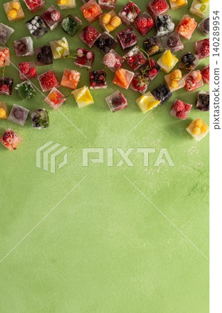 Ice cubes with frozen berries and fruits and mint on a green background Ice cubes with frozen berries and fruits and mint on a green background 140289954