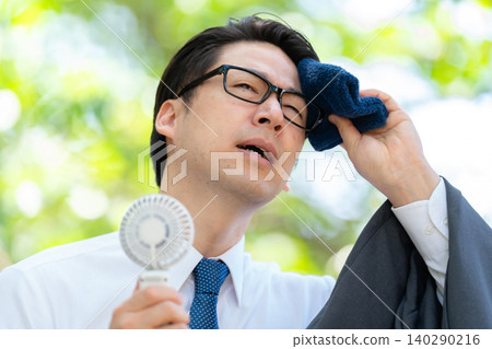 Businessman, extreme heat, handheld fan 140290216
