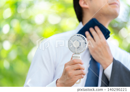 Businessman, extreme heat, handheld fan Businessman, extreme heat, handheld fan 140290221