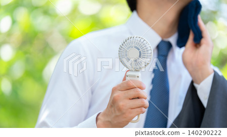 Businessman, extreme heat, handheld fan Businessman, extreme heat, handheld fan 140290222