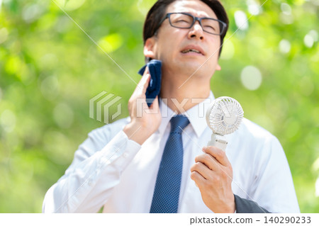 Businessman, extreme heat, handheld fan 140290233