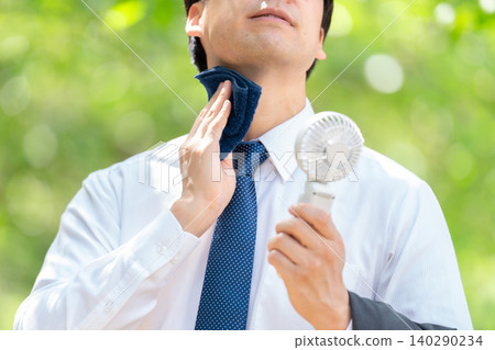 Businessman, extreme heat, handheld fan Businessman, extreme heat, handheld fan 140290234