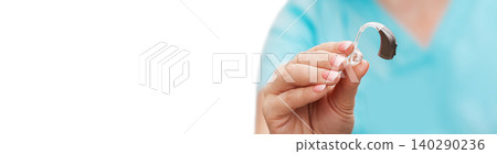Hearing aid in the hand of an audiologist, close-up. Selection of hearing aids. Hearing concept Hearing aid in the hand of an audiologist, close-up. Selection of hearing aids. Hearing concept 140290236