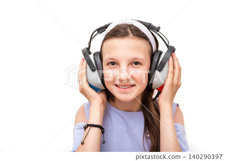 Hearing test. Positive girl in headphones during a hearing test, isolated on white. Audiometry 140290397