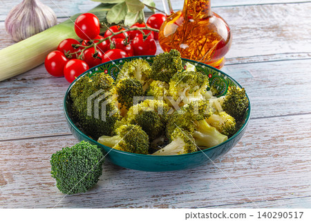 Fresh broccoli florets in decorative bowl with tomatoes and oil Fresh broccoli florets in decorative bowl with tomatoes and oil 140290517