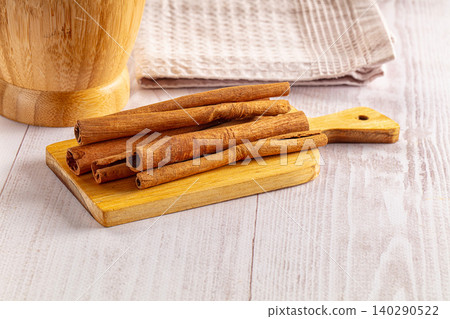 cinnamon sticks on wooden board cinnamon sticks on wooden board 140290522