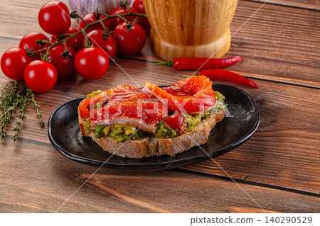 Smoked salmon avocado toast on wooden table Smoked salmon avocado toast on wooden table 140290529