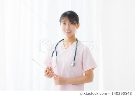 young female nurse in a white coat young female nurse in a white coat 140290548