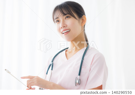 young female nurse in a white coat young female nurse in a white coat 140290550