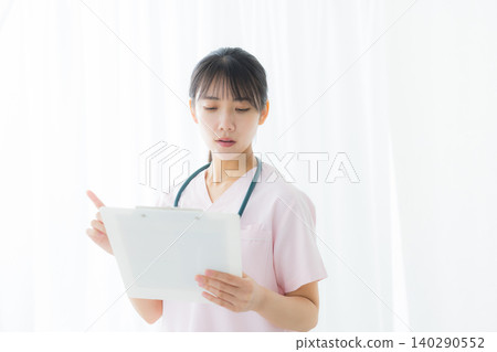 young female nurse in a white coat young female nurse in a white coat 140290552