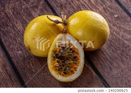 Fresh Yellow Passion Fruit on Dark Wooden Table Fresh Yellow Passion Fruit on Dark Wooden Table 140290625