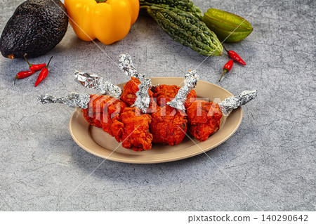 Chicken lollipop dish with vegetables on stone table Chicken lollipop dish with vegetables on stone table 140290642