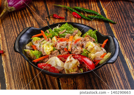 Tuna salad with fresh vegetables and peppers on wooden table Tuna salad with fresh vegetables and peppers on wooden table 140290663