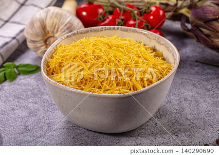 Bowl of dry spaghetti with fresh vegetables and garlic Bowl of dry spaghetti with fresh vegetables and garlic 140290690