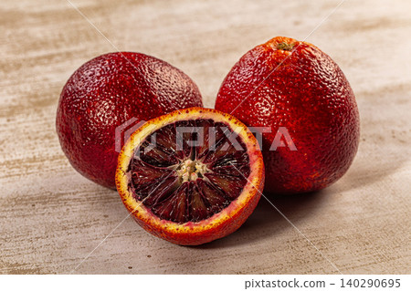 Three blood oranges on wooden surface Three blood oranges on wooden surface 140290695