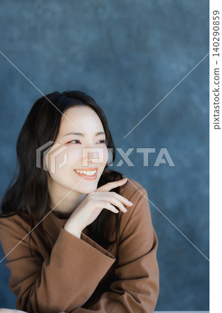 A woman smiling with a cheek A woman smiling with a cheek 140290859