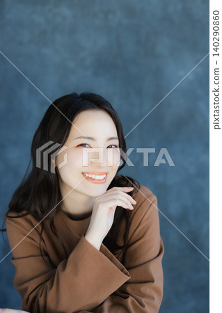 A woman smiling with a cheek A woman smiling with a cheek 140290860